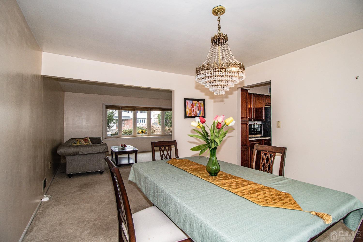29 Devon Drive Piscataway, NJ 08854 - Photo 8 of 23 a living room with furniture and a chandelier
