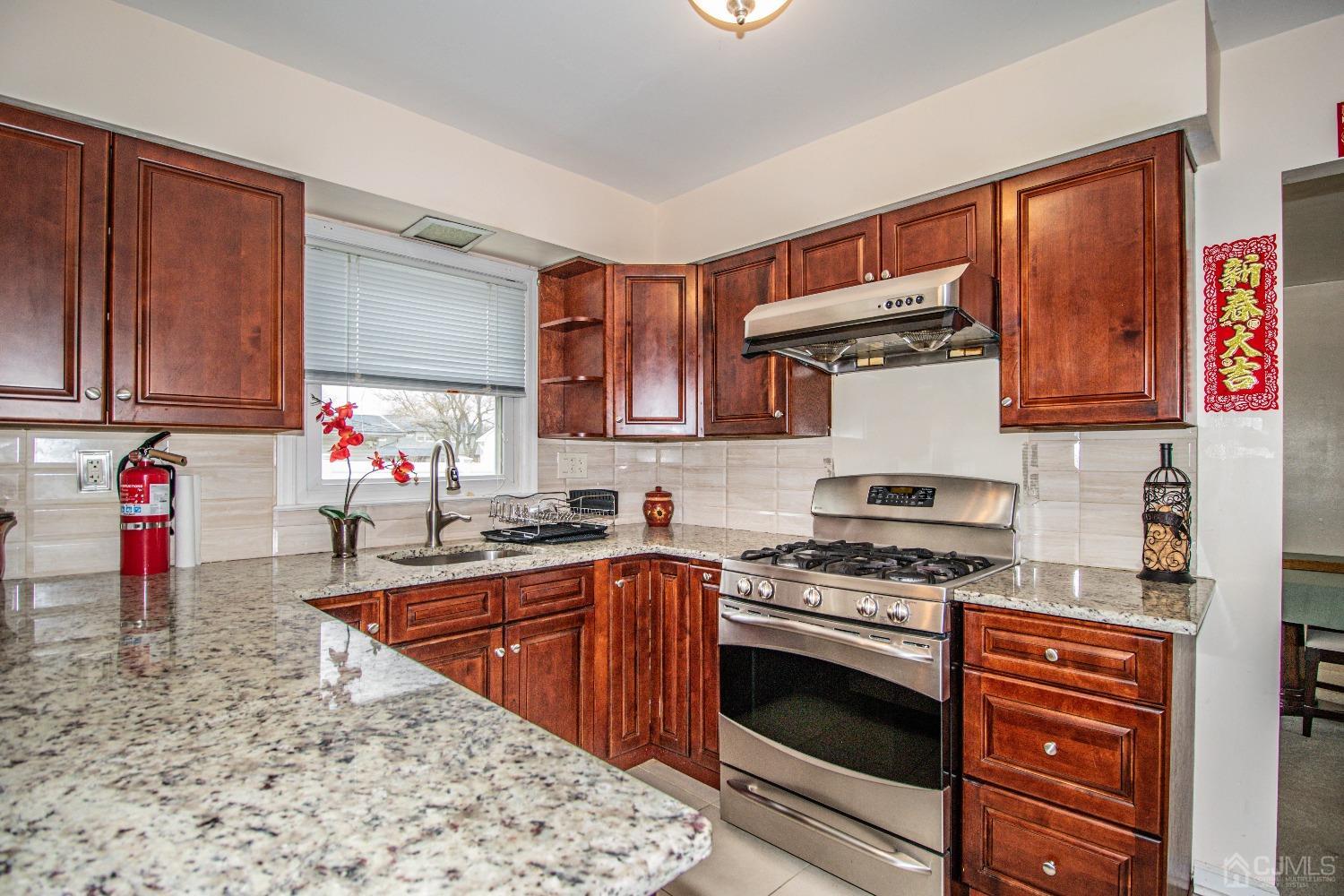 29 Devon Drive Piscataway, NJ 08854 - Photo 10 of 23 a kitchen with stainless steel appliances granite countertop a stove sink and cabinets