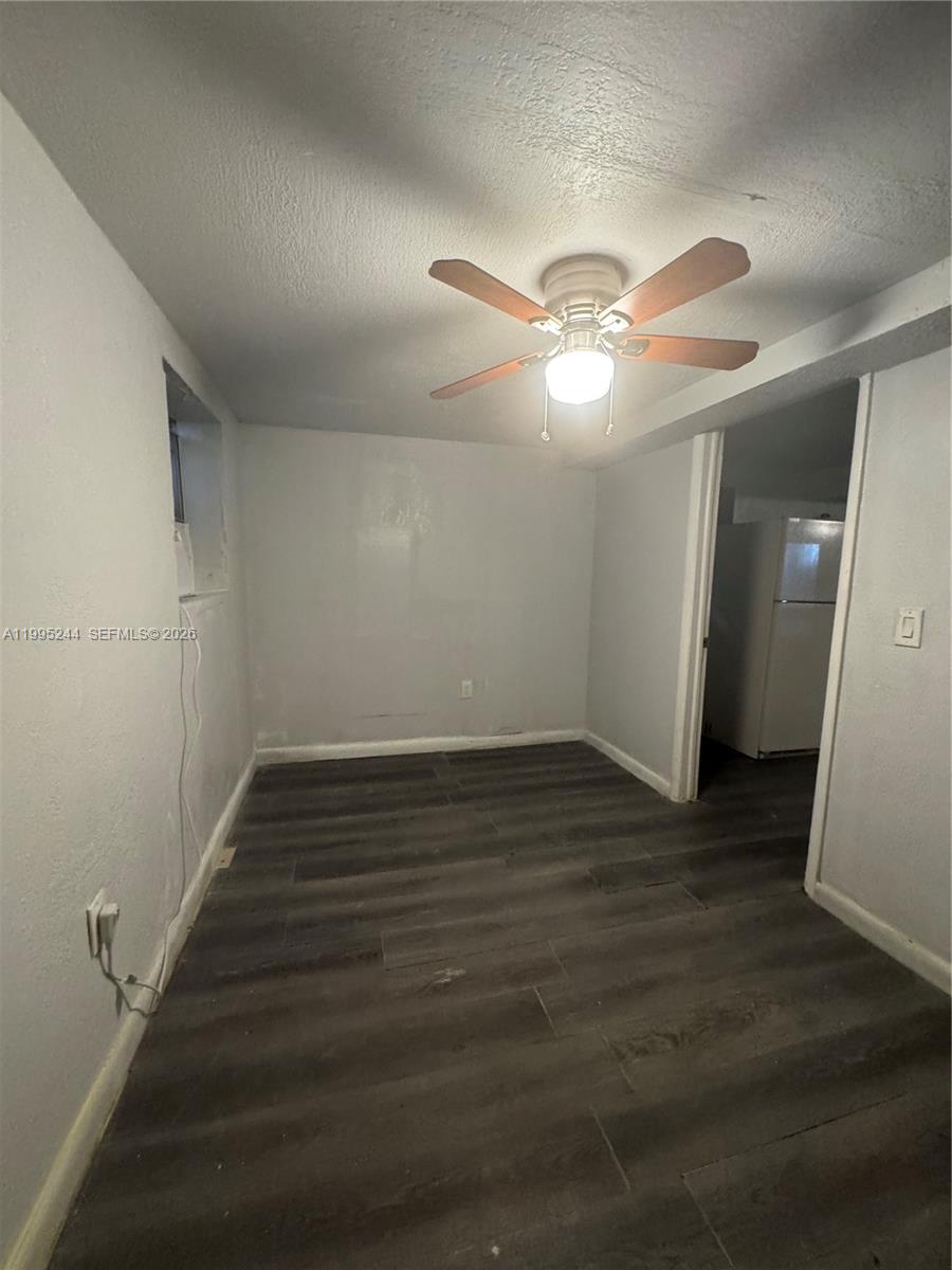 7802 Northwest 8th Avenue, Unit 5 Miami, FL 33150 - Photo 3 of 7 an empty room with wooden floor and fan