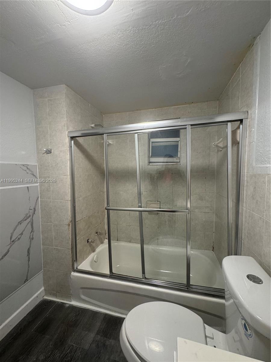 7802 Northwest 8th Avenue, Unit 5 Miami, FL 33150 - Photo 7 of 7 a bathroom with a toilet and a shower