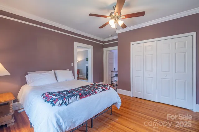 a bedroom with a large bed and a chandelier