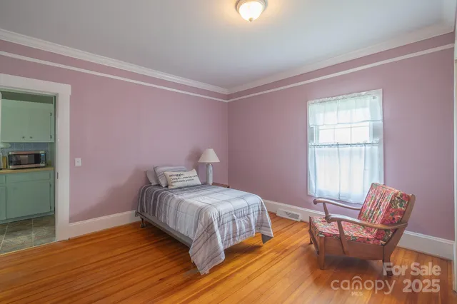 a bedroom with a bed and a chair