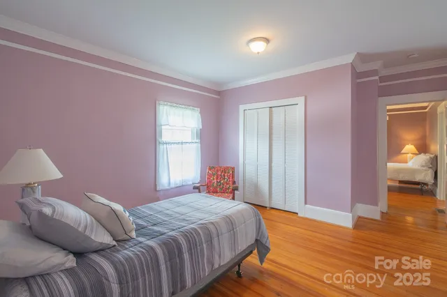 a bedroom with a bed and a potted plant