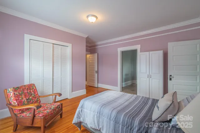 a bedroom with bed and chair