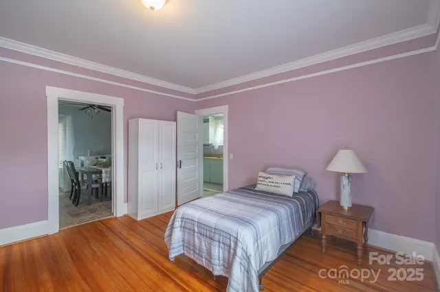 a bedroom with a bed and a lamp on table