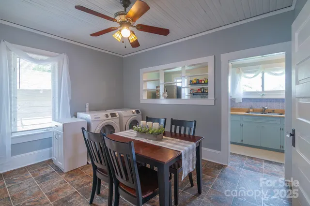 a view of a dining room with furniture and window