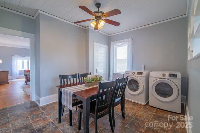 a view of a dining room with furniture and a chandelier