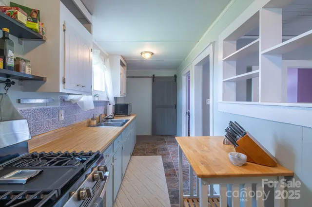 a kitchen with a stove and a wooden cabinets