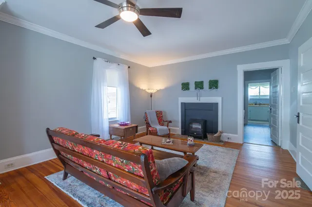 a living room with furniture a fireplace and wooden floor