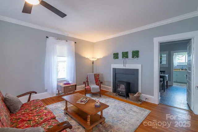 a living room with furniture a fireplace and a table