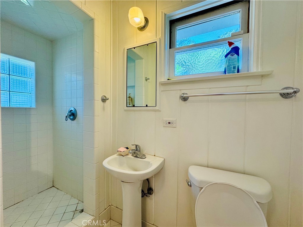 1777 La Cresta Drive Pasadena, CA 91103 - Photo 17 of 31 a bathroom with a sink and mirror with toilet