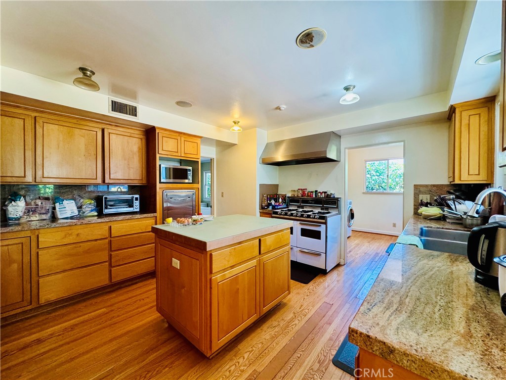 1777 La Cresta Drive Pasadena, CA 91103 - Photo 9 of 31 a kitchen with stainless steel appliances granite countertop a stove and a refrigerator
