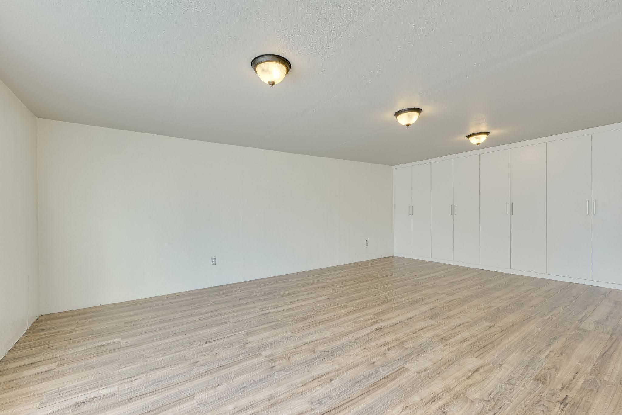 11612 Shoreview Overlook Austin, TX 78732 - Photo 24 of 40 Gleaming wood-inspired floors anchor this versatile room lined with seamless built-in storage closets.