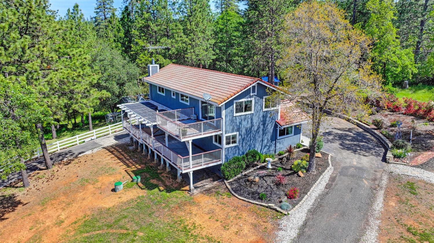 a view of a house with a yard and potted plants