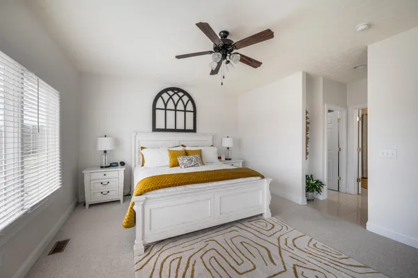 a bedroom with a bed and a chandelier