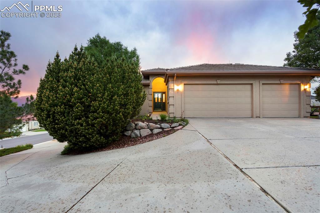 4120 Saddle Rock Road Colorado Springs, CO 80918 - Photo 11 of 50 a front view of a house with a yard and garage