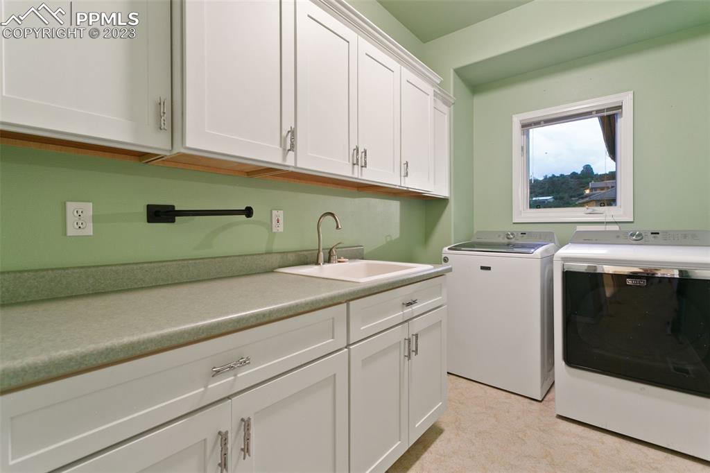 4120 Saddle Rock Road Colorado Springs, CO 80918 - Photo 14 of 50 a room with cabinets and washer
