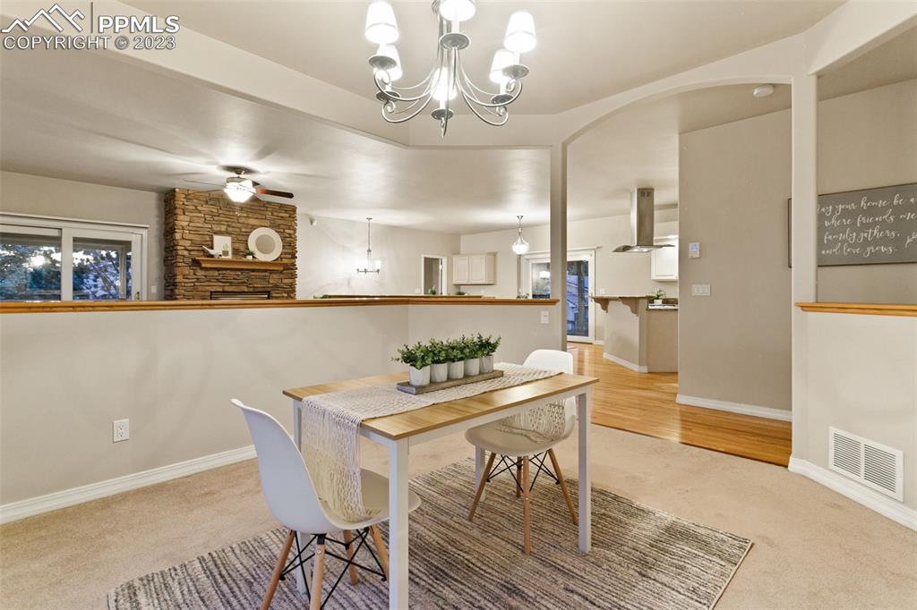 4120 Saddle Rock Road Colorado Springs, CO 80918 - Photo 18 of 50 a view of a dining room with furniture and chandelier