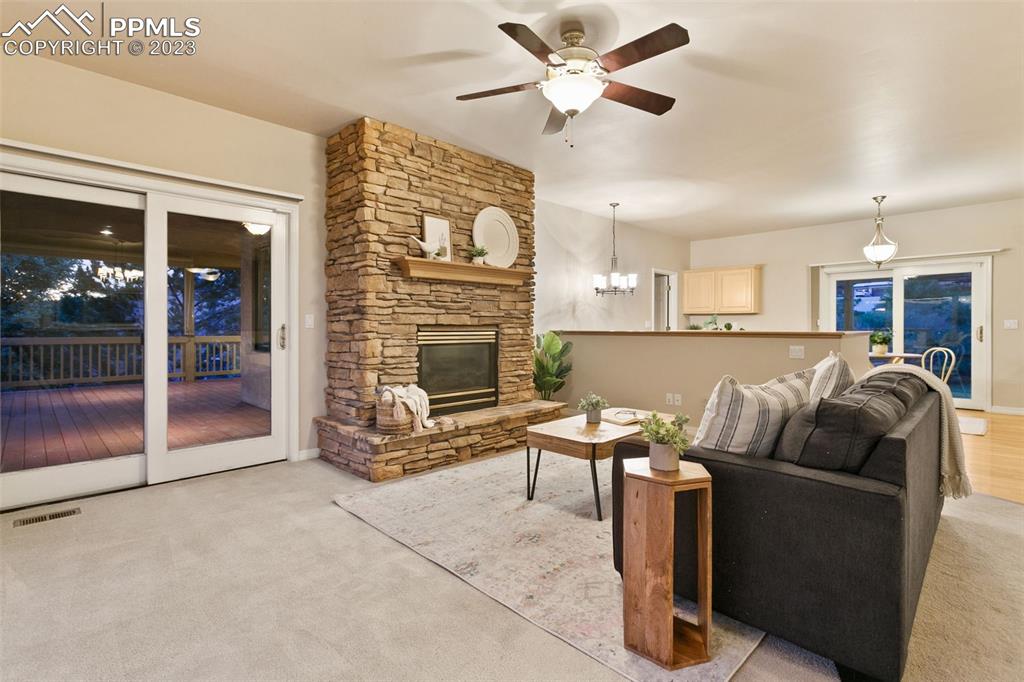 4120 Saddle Rock Road Colorado Springs, CO 80918 - Photo 20 of 50 a living room with furniture a fireplace and a flat screen tv