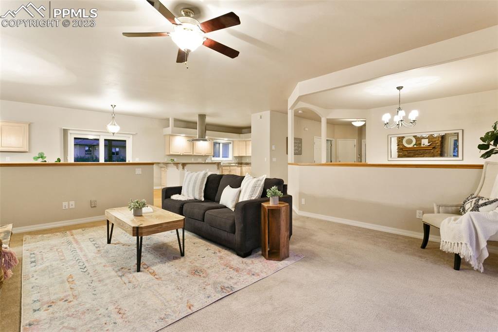 4120 Saddle Rock Road Colorado Springs, CO 80918 - Photo 21 of 50 a living room with furniture and a chandelier