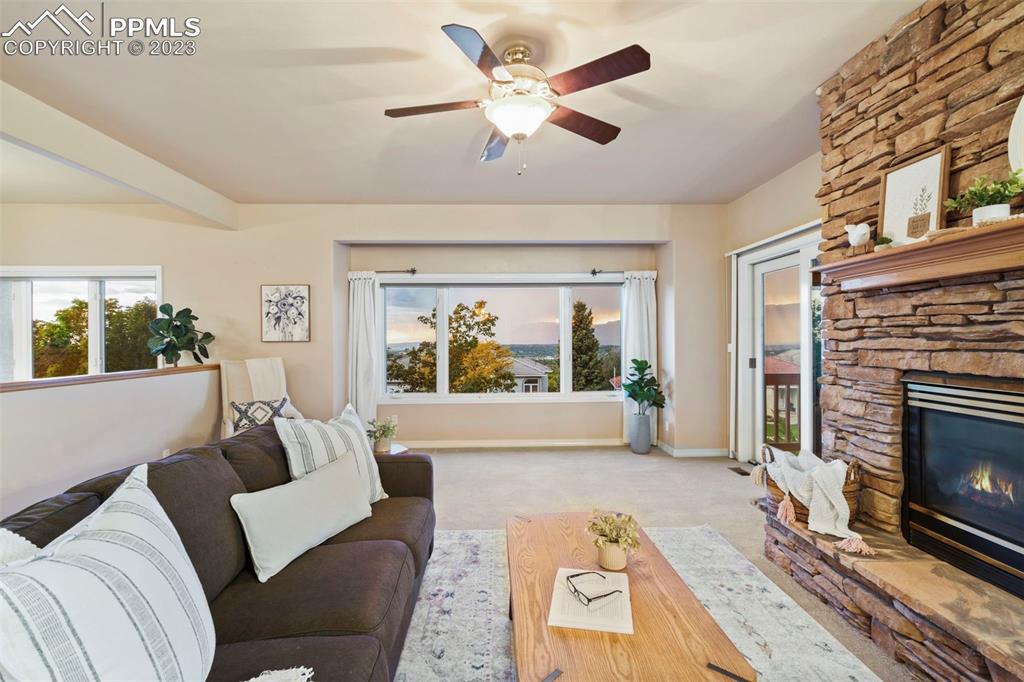 4120 Saddle Rock Road Colorado Springs, CO 80918 - Photo 23 of 50 a living room with furniture and a fireplace