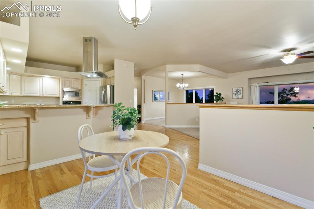 4120 Saddle Rock Road Colorado Springs, CO 80918 - Photo 25 of 50 a view of a dining room with furniture and wooden floor