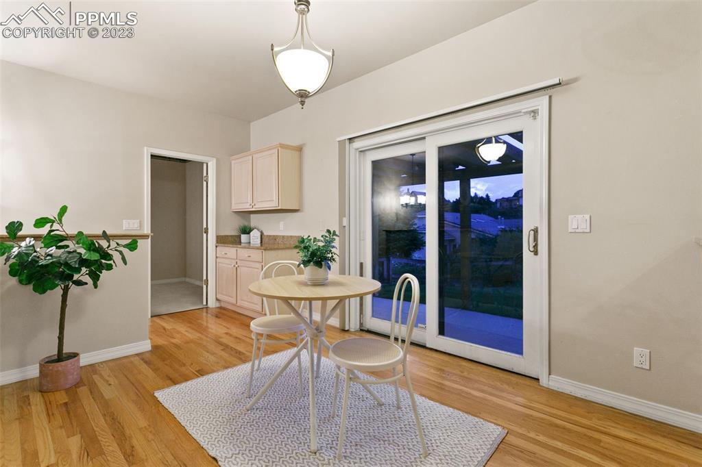 4120 Saddle Rock Road Colorado Springs, CO 80918 - Photo 26 of 50 a view of a dining room with furniture window and wooden floor