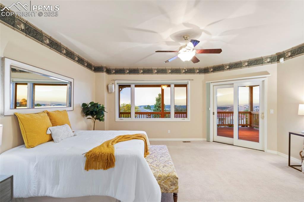 4120 Saddle Rock Road Colorado Springs, CO 80918 - Photo 30 of 50 a spacious bedroom with a large bed and a large window