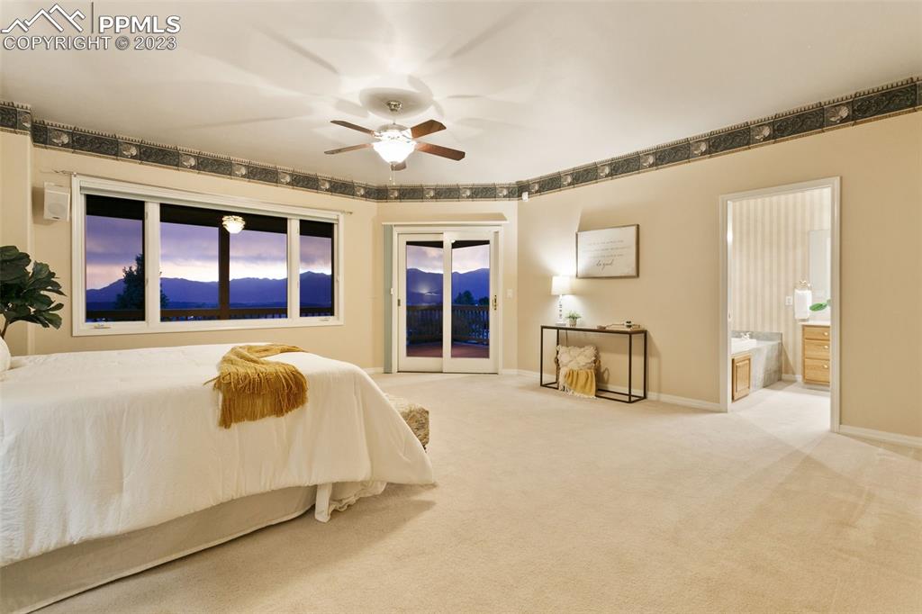 4120 Saddle Rock Road Colorado Springs, CO 80918 - Photo 33 of 50 a spacious bedroom with a bed and a large cabinets