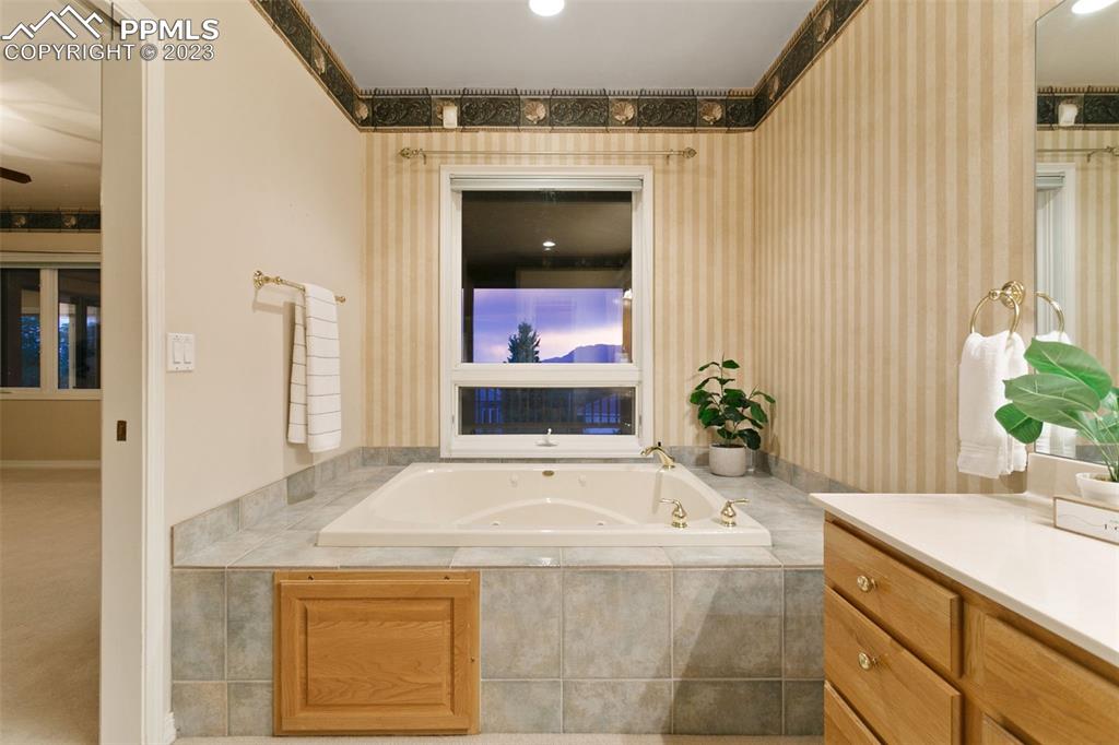 4120 Saddle Rock Road Colorado Springs, CO 80918 - Photo 36 of 50 a bathroom with a granite countertop sink and a mirror