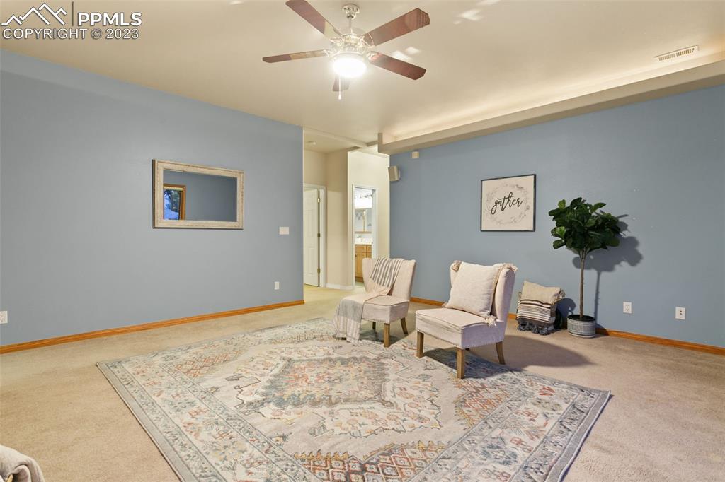 4120 Saddle Rock Road Colorado Springs, CO 80918 - Photo 40 of 50 a living room with furniture and a chandelier