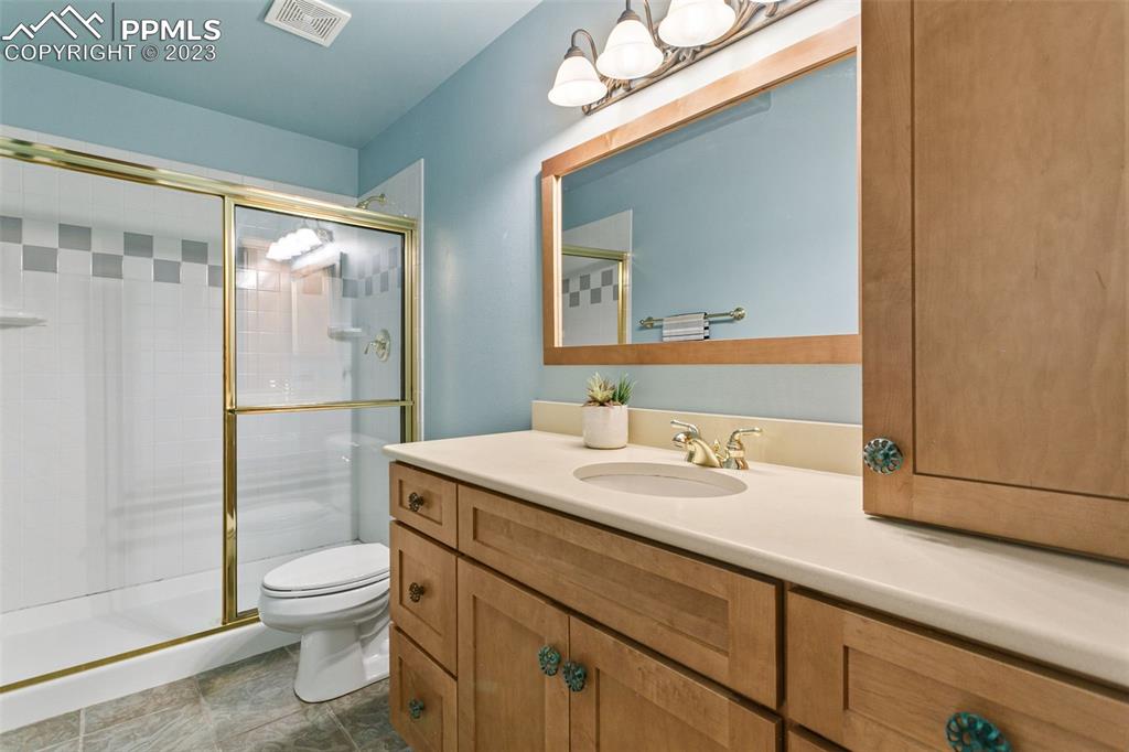 4120 Saddle Rock Road Colorado Springs, CO 80918 - Photo 43 of 50 a bathroom with a sink a toilet and shower
