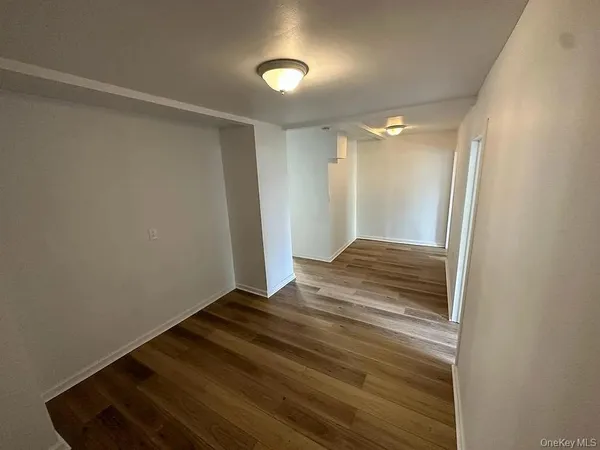 a view of an empty room and wooden floor