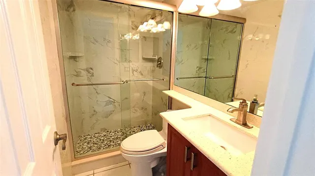 a bathroom with a sink toilet and shower