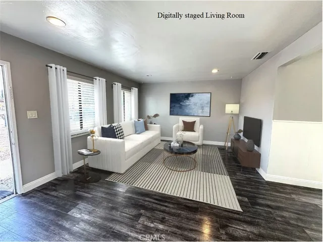 a living room with furniture or couch and a wooden floor