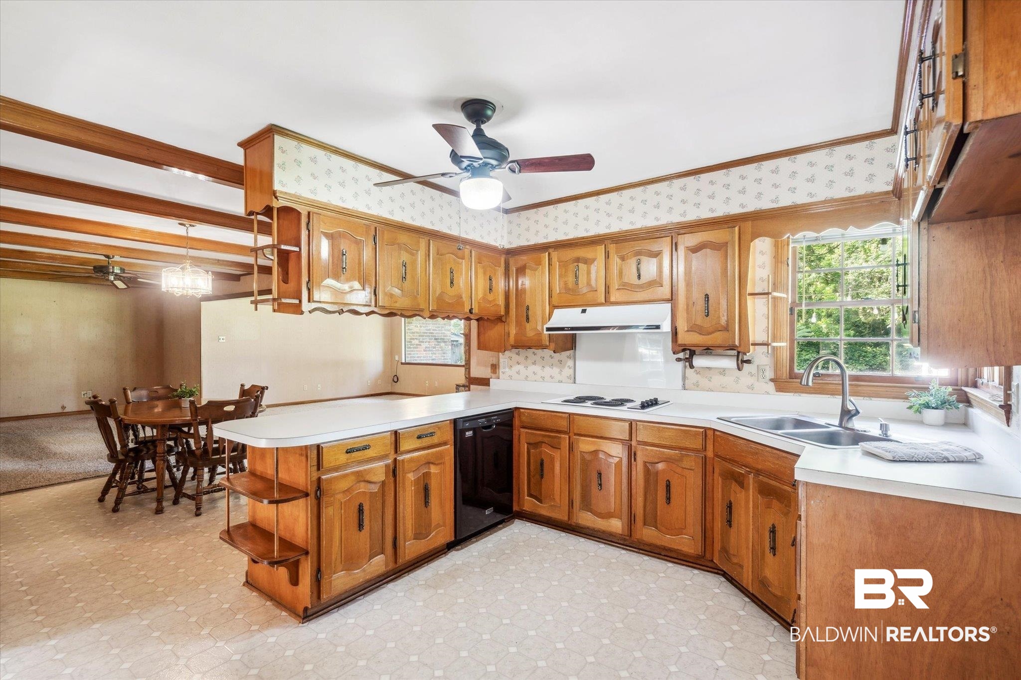 1252 Helm Circle Mobile, AL 36693 - Photo 6 of 18 Kitchen with ceiling fan, kitchen peninsula, sink, white cooktop, and light tile patterned floors