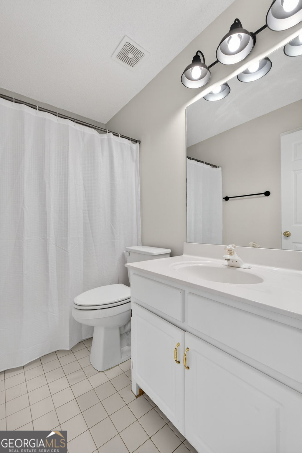 955 Mocassin Gap Road Locust Grove, GA 30248 - Photo 29 of 59 a bathroom with a toilet sink and mirror