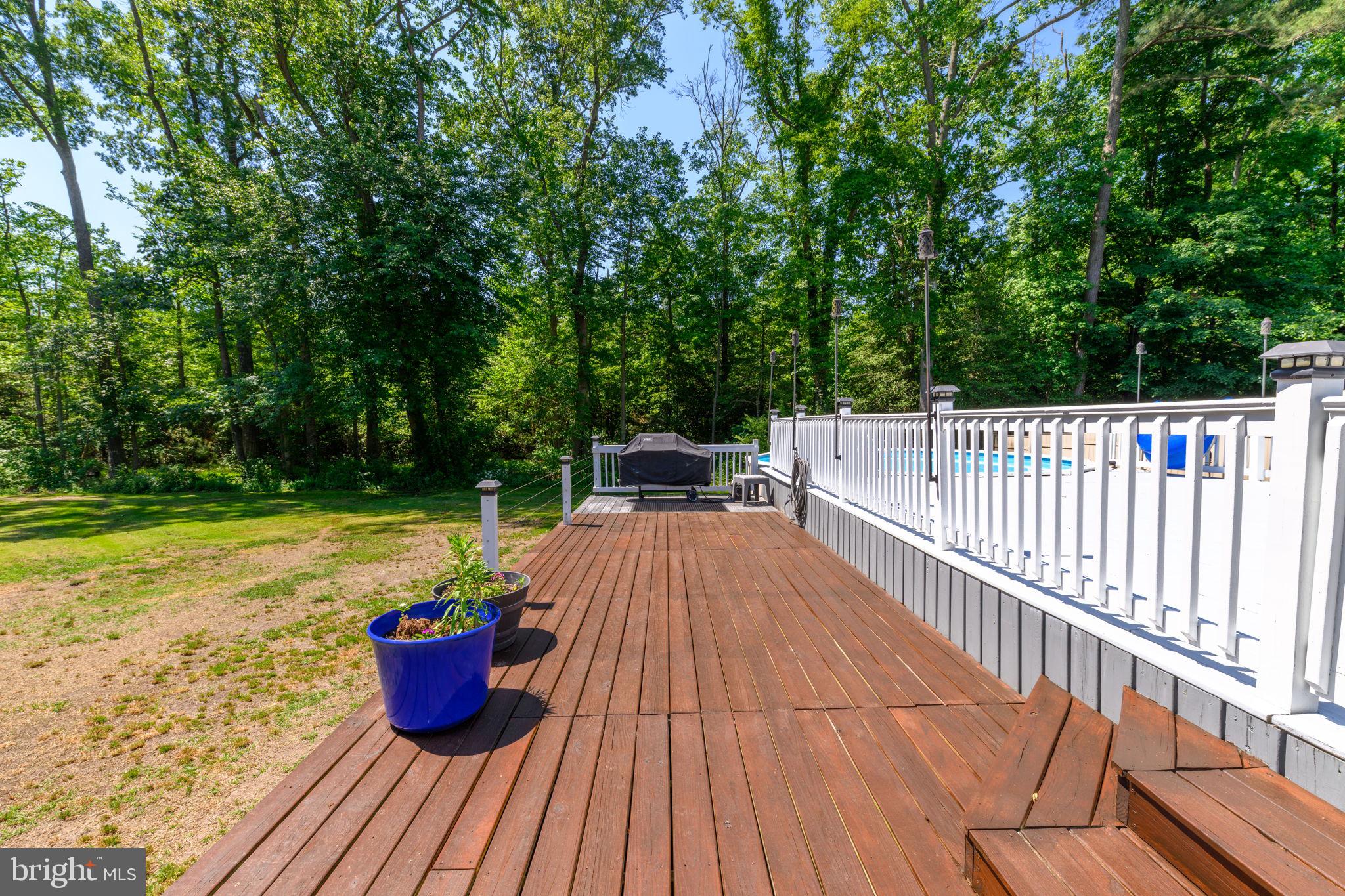 4563 Nutters Cross Road Salisbury, MD 21804 - Photo 12 of 52 a view of a roof deck with a table and chairs