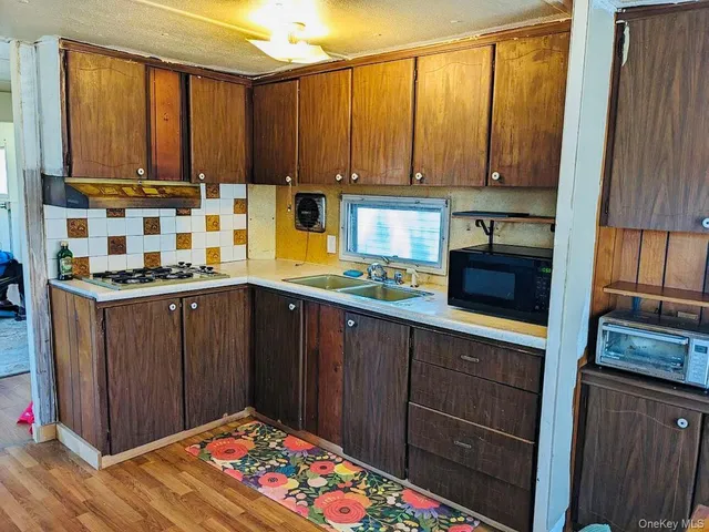 a kitchen with stainless steel appliances granite countertop a refrigerator and cabinets