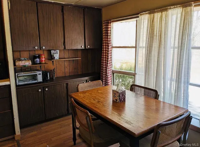 a kitchen with a table chairs and cabinets