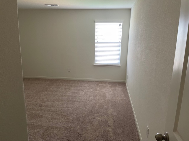 18741 Speculator Lane Elgin, TX 78621 - Photo 19 of 28 Unfurnished room featuring carpet flooring and a textured wall