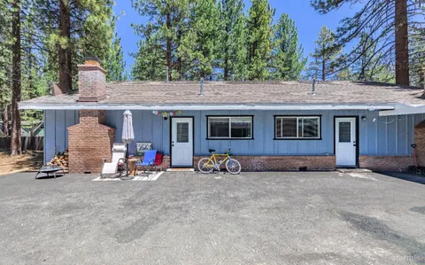 a view of a house with patio outdoor seating and a tree