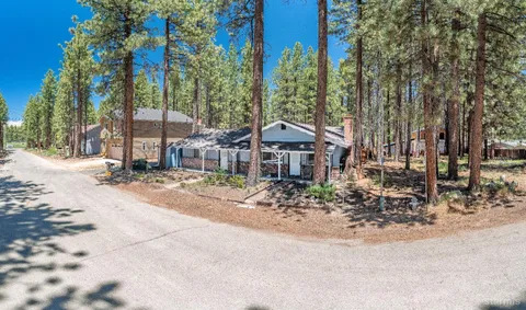 a view of a house with a yard and sitting area