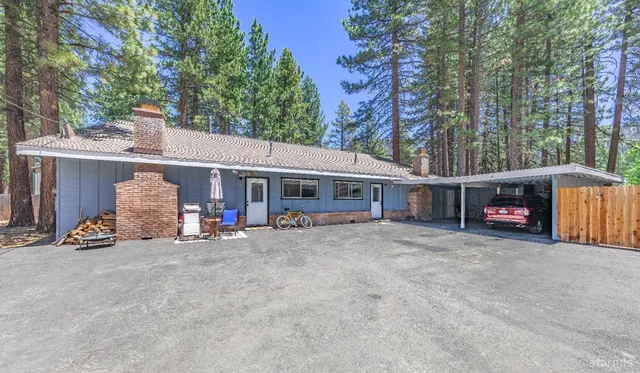 a view of a house with large space and a car parked beside it