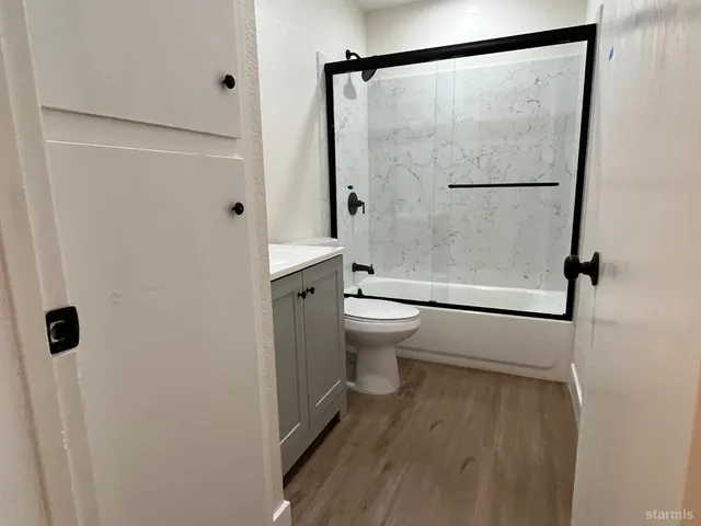 a view of a hallway with wooden floor