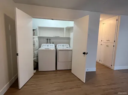 a utility room with cabinets washer and dryer