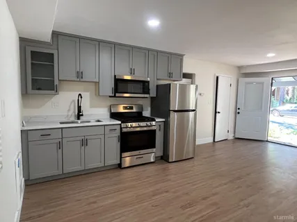 a kitchen with stainless steel appliances a refrigerator stove and sink