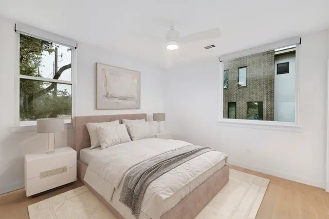 a bedroom with a large bed and a window