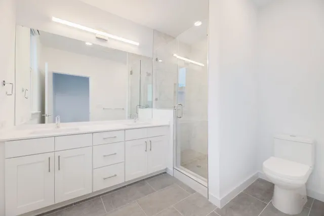 a bathroom with a toilet a sink and mirror