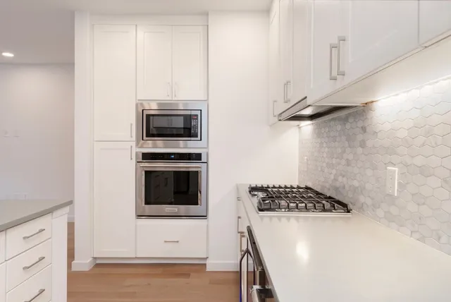 a kitchen with a stove and a microwave